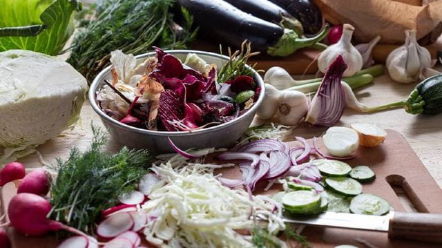 chopping board with various leftover vegetables